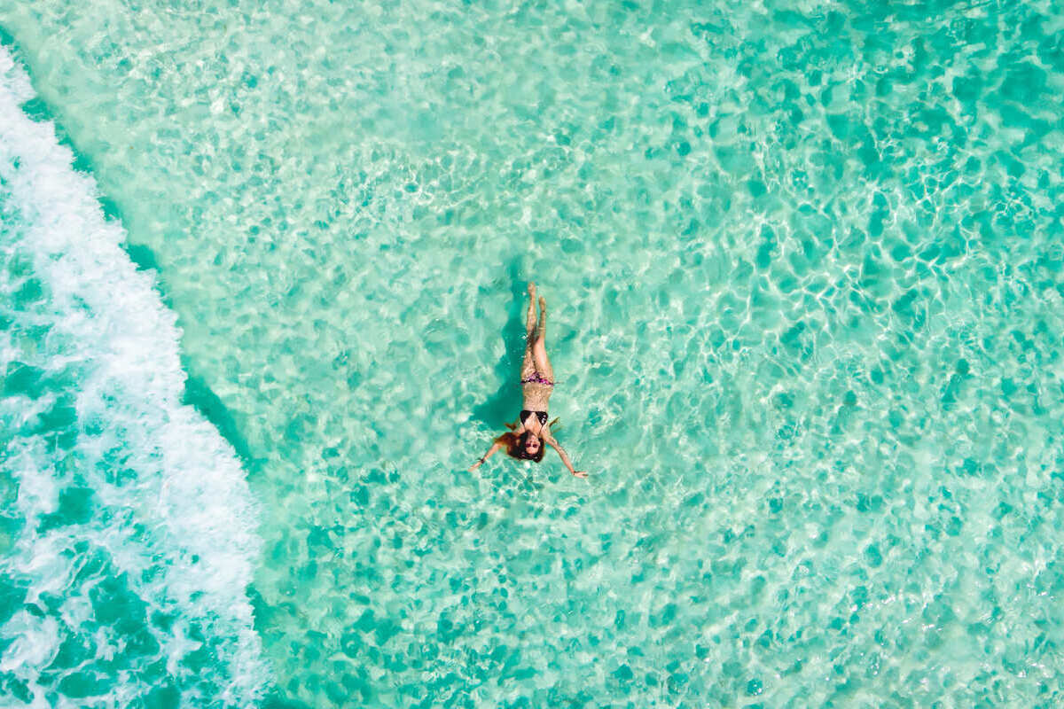 Young Woman Floating In The Caribbean Sea In Mexico